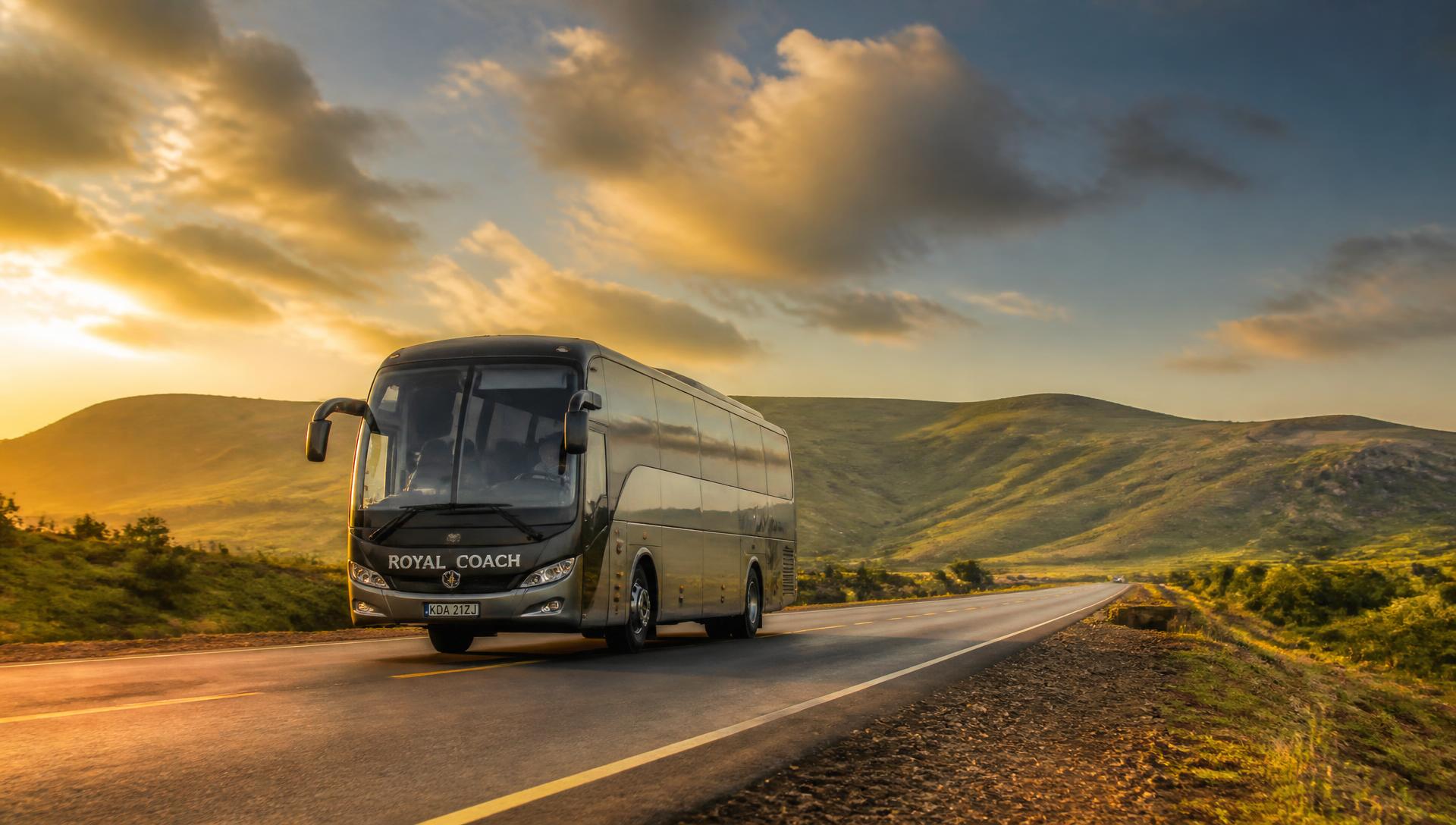 Trinity Express coach travelling an East African highway at sunset
